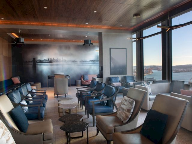 A lounge area with a city view and comfortable seating.